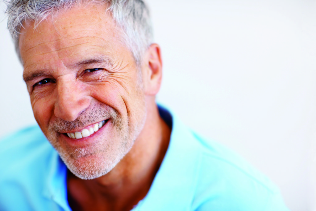Closeup portrait of a happy mature man on white background